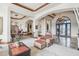 Living room with elegant chandeliers, arched doorways, and comfortable seating at 12160 E Whispering Wind Dr, Scottsdale, AZ 85255