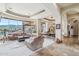 Spacious living room featuring comfortable seating, mountain views, and elegant stone flooring at 12160 E Whispering Wind Dr, Scottsdale, AZ 85255