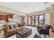 Inviting living area with tile flooring, comfortable seating, and french doors to patio at 12160 E Whispering Wind Dr, Scottsdale, AZ 85255