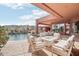 A comfortable patio set sits by the pool and showcases an outdoor fireplace with views of the mountains beyond at 12160 E Whispering Wind Dr, Scottsdale, AZ 85255