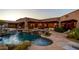 An amazing outdoor space featuring a beautiful pool, spa, waterfall and an outdoor seating area at 12160 E Whispering Wind Dr, Scottsdale, AZ 85255