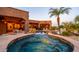 Relaxing pool with spa, rock features, and covered patio perfect for enjoying the outdoor living space at 12160 E Whispering Wind Dr, Scottsdale, AZ 85255