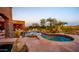 A calming backyard showcases a pool, spa, outdoor seating, and landscaping for relaxing resort-style living at 12160 E Whispering Wind Dr, Scottsdale, AZ 85255