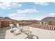 Outdoor seating area on a roof deck offering panoramic mountain views and blue skies at 12160 E Whispering Wind Dr, Scottsdale, AZ 85255