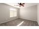 Neutral bedroom featuring a ceiling fan, carpet, and a window that provides natural light at 1244 W Castle Dr, Casa Grande, AZ 85122