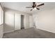 Bedroom with sliding closet doors, neutral carpet, and open door leading to bathroom at 1244 W Castle Dr, Casa Grande, AZ 85122