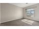 Bedroom with neutral paint, carpet, and a window featuring decorative plants at 1244 W Castle Dr, Casa Grande, AZ 85122