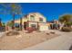 Inviting two-story home featuring a neutral color scheme, manicured landscaping, and an attached two-car garage at 1244 W Castle Dr, Casa Grande, AZ 85122