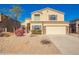 Inviting two-story home featuring a neutral color scheme, manicured landscaping, and an attached two-car garage at 1244 W Castle Dr, Casa Grande, AZ 85122