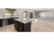 Elegant kitchen showcasing dark wood cabinetry, a center island, and a seamless transition to living areas at 1244 W Castle Dr, Casa Grande, AZ 85122