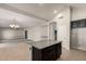 Open-concept kitchen with granite island flowing into a spacious living area with a modern chandelier at 1244 W Castle Dr, Casa Grande, AZ 85122