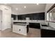 Bright kitchen boasting dark cabinets, granite countertops, and stainless steel sink at 1244 W Castle Dr, Casa Grande, AZ 85122