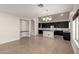 Open floor plan showcasing a modern kitchen with a granite island and a living area with ample natural light at 1244 W Castle Dr, Casa Grande, AZ 85122