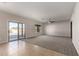 Open living room featuring neutral colors, a ceiling fan, and a sliding door to the backyard pool at 1244 W Castle Dr, Casa Grande, AZ 85122