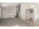 Bright living room with plush carpet, vaulted ceiling, neutral color scheme, and an arched entry to the hallway at 1244 W Castle Dr, Casa Grande, AZ 85122