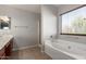 Bright bathroom with a garden tub, shower and a large window offering natural light at 1244 W Castle Dr, Casa Grande, AZ 85122