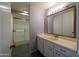 Bathroom featuring a single sink vanity and step-in shower with sliding glass doors at 13623 N 108Th Dr, Sun City, AZ 85351