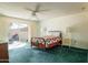 Bedroom with sliding glass doors to the patio area and a comfy bed and ceiling fan at 13623 N 108Th Dr, Sun City, AZ 85351