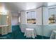 Light-filled bedroom featuring a vanity table, window shutters, and plush carpeting at 13623 N 108Th Dr, Sun City, AZ 85351