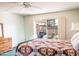 Bedroom with bright natural light from the glass doors, ceiling fan, and bed with patterned quilt at 13623 N 108Th Dr, Sun City, AZ 85351