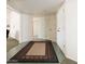 A bright entryway with tile flooring, neutral walls, and a decorative rug at 13623 N 108Th Dr, Sun City, AZ 85351