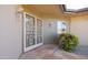 Inviting front porch with stone detail, security door, and meticulously maintained landscaping at 13623 N 108Th Dr, Sun City, AZ 85351