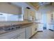 A well-lit kitchen with white cabinetry, stainless steel appliances, and tiled floors at 13623 N 108Th Dr, Sun City, AZ 85351