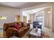 Cozy living room with comfortable seating, hardwood floors, and sliding glass doors to the patio at 13623 N 108Th Dr, Sun City, AZ 85351