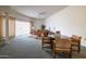 Open-concept living room with a view to the dining area, comfortable seating, and abundant natural light at 13623 N 108Th Dr, Sun City, AZ 85351