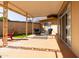 A covered patio featuring blue cushioned seating with an outdoor rug and a red Adirondack chair at 13623 N 108Th Dr, Sun City, AZ 85351