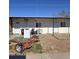 Exterior view of the property showcasing two white doors and a trailer on the ground at 1414 E Moreland St, Phoenix, AZ 85006