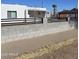 The home has a xeriscaped front yard and a gray block perimeter wall with a black fence on top at 1414 E Moreland St, Phoenix, AZ 85006