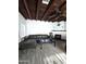 Living room with tile floor, dark-stained wood beam ceiling, black leather sofa and small fireplace at 1414 E Moreland St, Phoenix, AZ 85006