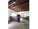 Living room with exposed wood ceiling, tile floors, and brown recliner at 1414 E Moreland St, Phoenix, AZ 85006