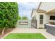 The outdoor space features a built-in tiled fountain and an outdoor kitchen with a black metal fence at 14360 W Windrose Dr, Surprise, AZ 85379