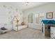 Charming bedroom with unique playhouse bed, leafy wallpaper, and bright natural light at 14360 W Windrose Dr, Surprise, AZ 85379