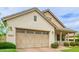 View of a well-maintained home exterior highlighting the attached garage and tidy landscaping at 14360 W Windrose Dr, Surprise, AZ 85379