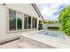 An elevated hot tub complemented by tile and stone accents offers a tranquil escape in this stylish backyard retreat at 14360 W Windrose Dr, Surprise, AZ 85379