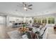 Bright, open-concept living room featuring a large gray sectional sofa and a ceiling fan at 14360 W Windrose Dr, Surprise, AZ 85379