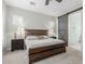 The primary bedroom includes a wooden bed frame, bedside tables, and a sliding barn door to the main bathroom at 14360 W Windrose Dr, Surprise, AZ 85379