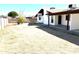 Spacious home backyard and brick perimeter wall with covered patio at 1440 E Grove Ave, Mesa, AZ 85204