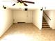 Finished basement featuring tile flooring, ceiling fans, and staircase, perfect for a media room at 1440 E Grove Ave, Mesa, AZ 85204