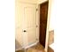 Bathroom featuring custom wood cabinet with full height cabinet, a tile floor, and a white door at 1440 E Grove Ave, Mesa, AZ 85204