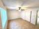 Bedroom featuring a large window, tile floor, and dual door closet at 1440 E Grove Ave, Mesa, AZ 85204