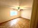 A bright bedroom with a ceiling fan and tile floors at 1440 E Grove Ave, Mesa, AZ 85204