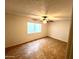 A bright bedroom with a ceiling fan and tile floors at 1440 E Grove Ave, Mesa, AZ 85204