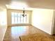 Bright dining room featuring a large window and decorative light fixture at 1440 E Grove Ave, Mesa, AZ 85204