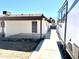 Image of home's covered back patio, including a camper parked alongside at 1440 E Grove Ave, Mesa, AZ 85204