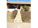 Landscaped front yard with stone path leading to a cozy brick home with a welcoming entrance at 1440 E Grove Ave, Mesa, AZ 85204