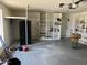 The garage is spacious with lots of wall storage and white epoxy flooring at 1440 E Grove Ave, Mesa, AZ 85204